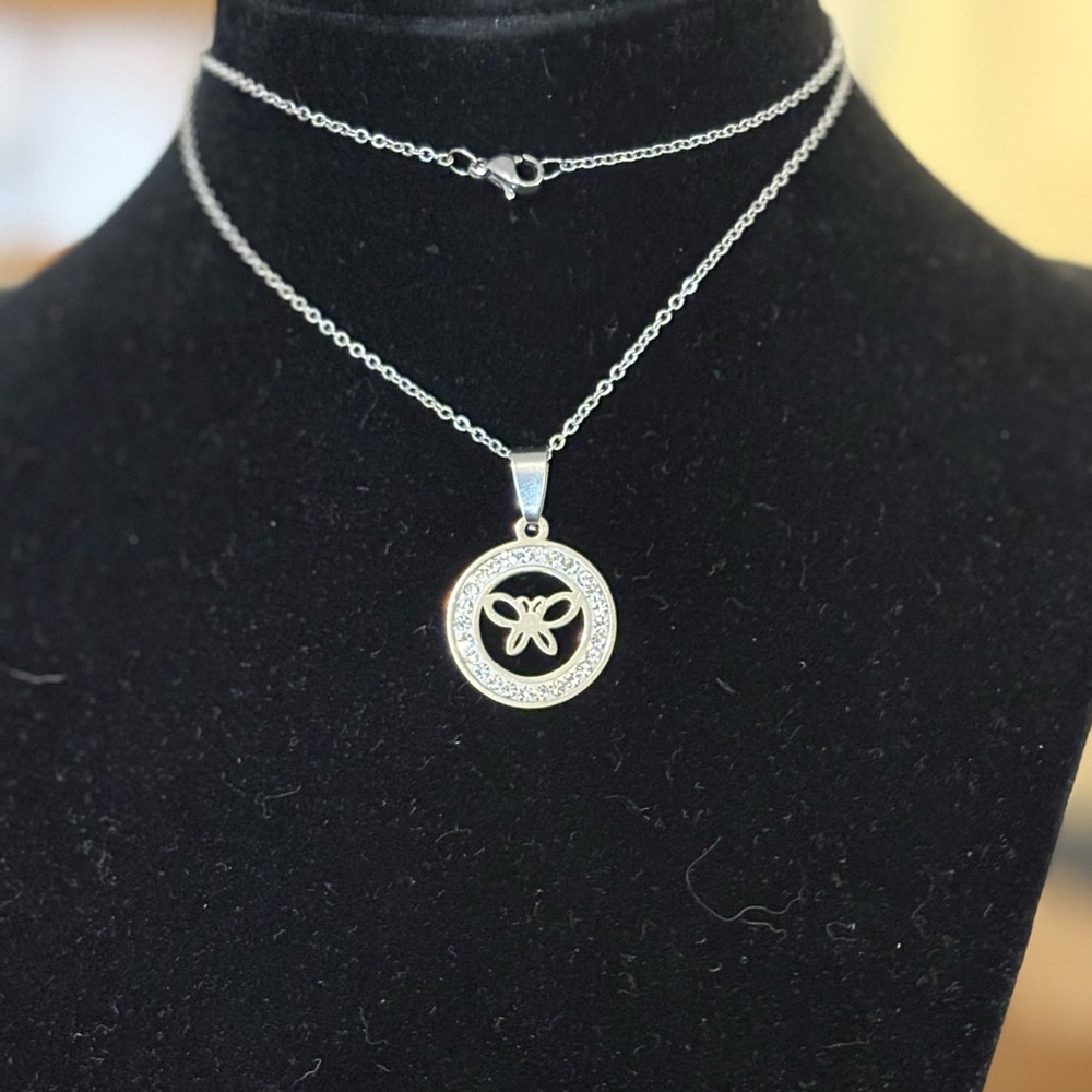 18” stainless steel and cubic zirconia necklace and pendant with a butterfly.
